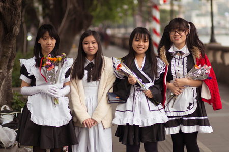 Guangzhou, China - MARCH 15, 2016: Four Chinese smiling pretty student girls in school wear with flowersのeditorial素材