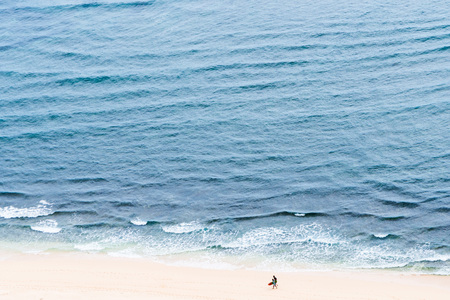Two people on the sand beach oceanの写真素材