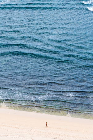 Alone people on the ocean sand beachの写真素材