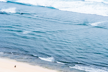 Two people on the sand beach oceanの写真素材