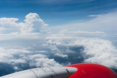 Clouds, sky and engine from the plane windowの写真素材