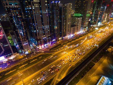 Night view of Dubai city with roads, skyscrapers and bright lightsの写真素材
