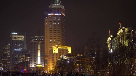 Shanghai, China - January 15, 2018: People walk along the embankment of Vaitan in the evening. The Bund or Waitan is a waterfront area in central Shanghai.のeditorial素材