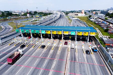 Toll roads on the broad highway. Through the point passes a large number of trucks and cars. Top down view of a quadcopterの写真素材