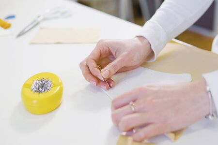 Woman freelancer, fashion designer or tailor working on a design or draft with colorful fabrics in workshop. Close upの写真素材