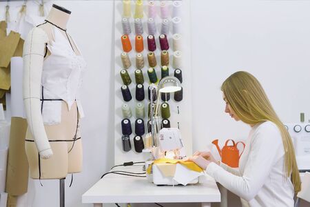 Dressmaker woman working with sewing machineの写真素材