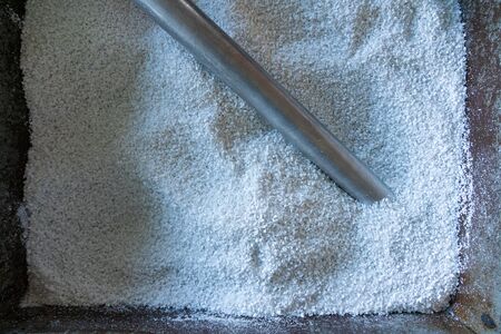 raw plastic material white granules in metal boxの写真素材