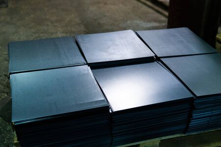 Steel sheets deposited in stacks in packs at the warehouse of metal products. Weathered metals sheet for construction. Metal corrosionの写真素材