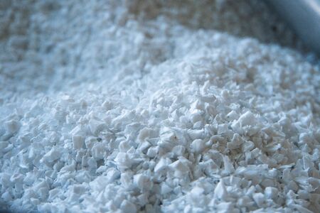 raw plastic material white granules in metal boxの写真素材