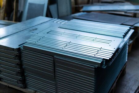 Steel sheets deposited in stacks in packs at the warehouse of metal products. Weathered metals sheet for construction. Metal corrosionの写真素材