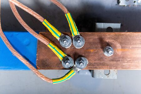 copper busbar, colored wires on metal base. Part of transformerの写真素材