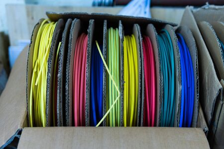 coils with multi-colored electrical wires in the boxの写真素材
