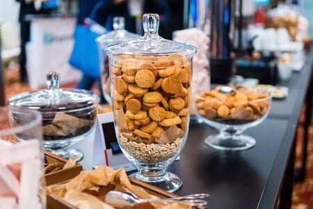 Shortbread cookies in glassware and other sweets on the buffet table during the coffee breakの写真素材