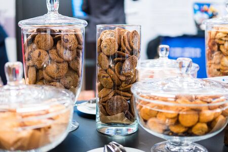 Shortbread cookies in glassware and other sweets on the buffet table during the coffee breakの写真素材