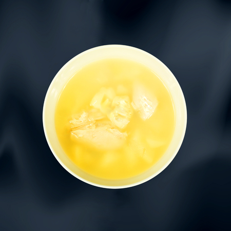 Soup. Bowl with golden chicken broth on dark background. Steam. Top viewの写真素材