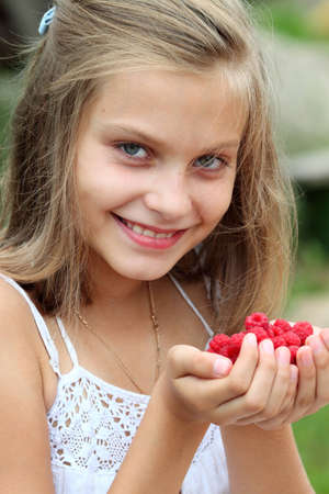 girl with raspberry in her handsの写真素材