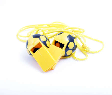 two of the judges ' whistle for games in football isolated on whiteの写真素材