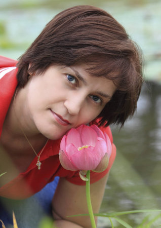 portrait of young woman with lotus flowerの写真素材