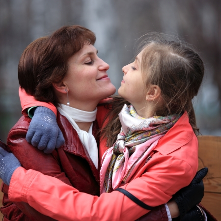 young mother and daughter  looking eyes in the eyes of each otherの写真素材