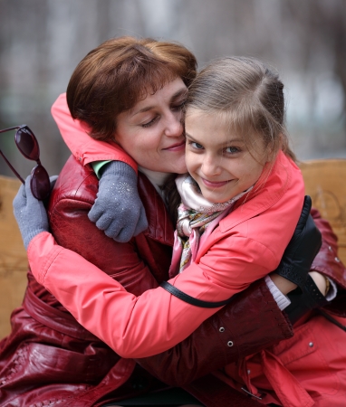 mother hug her smiling daughterの写真素材