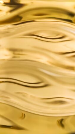 Orange and yellow background of abstract warm curves, hot wave, continuous lines with neon glow. template for card or banner. can be used for background or wallpaperの写真素材