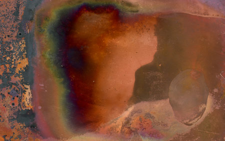 abstract background with spots and stains of oil paint on a rusty metal surfaceの写真素材