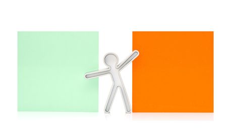 figure with an orange and green placard on a white backgroundの写真素材