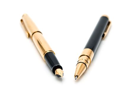 gold pens on a white backgroundの写真素材