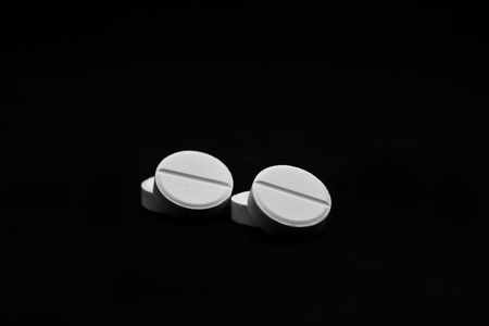 white pills on a black background