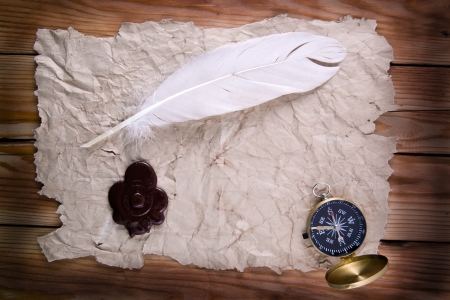 old paper and compass on a wooden background の写真素材