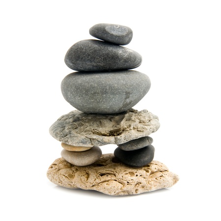 pyramid from smooth stone on a white background の写真素材