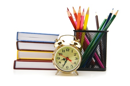 books, clock and pencils on a white background の写真素材
