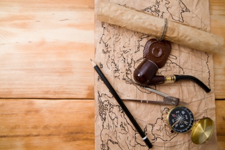 map and compass on a wooden background 