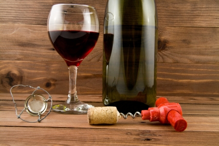 glass of wine and bottle on a wooden backgroundの写真素材