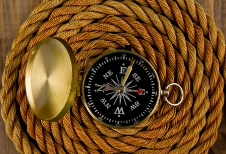 compass and rope on a wooden table の写真素材