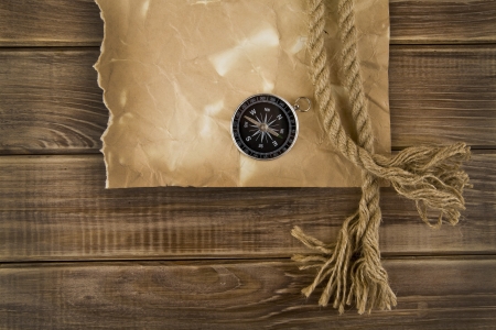 old paper and compass on a wooden background の写真素材