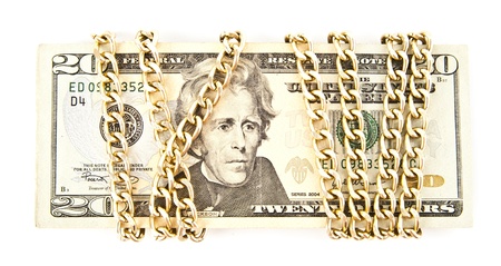 dollars and a chain on a white backgroundの写真素材