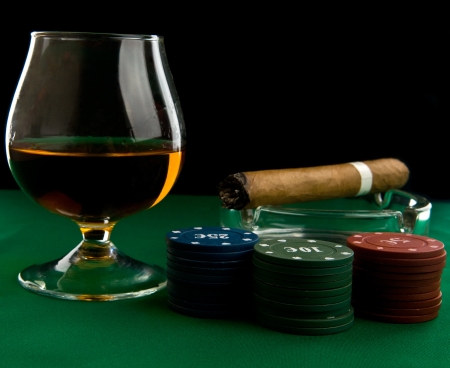 alcohol, chips and cigar on a black backgroundの写真素材