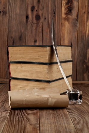 old books and pen on a wooden tableの写真素材