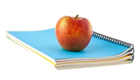 apple and notebooks on a white backgroundの写真素材