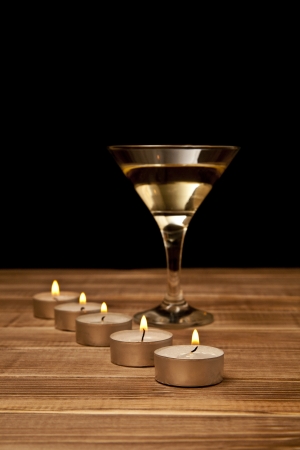 Martini and candles on a black backgroundの写真素材