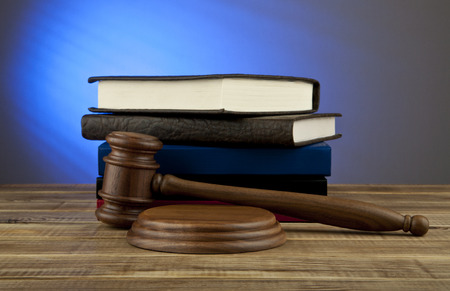 Wooden gavel and books on wooden tableの写真素材