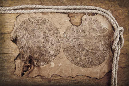 old paper and a compass on a wooden background