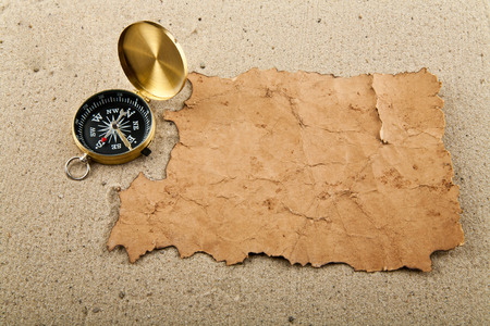 compass and old paper on sandの写真素材