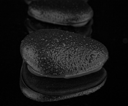 stone in drops on a black backgroundの写真素材