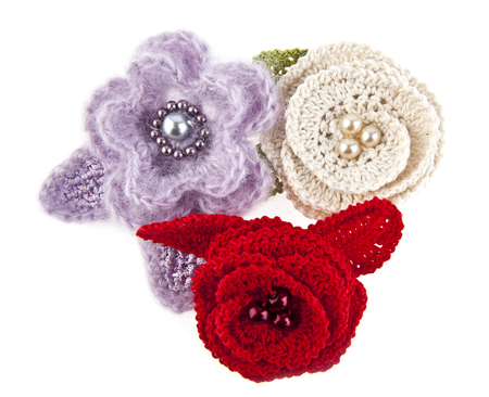 knitted handmade flowers isolated on white backgroundの写真素材