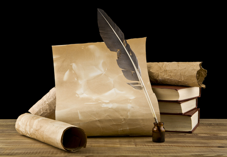 old books and pen on a black backgroundの写真素材