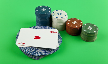 playing cards with chips on a green backgroundの写真素材
