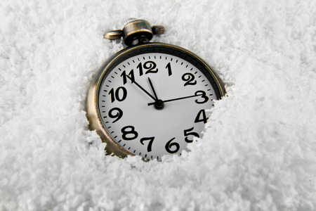 Watch in retro style in the snow before Christmas or New Year.の写真素材