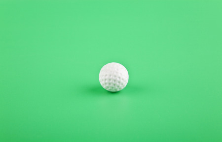 Golf ball on green background closeupの写真素材